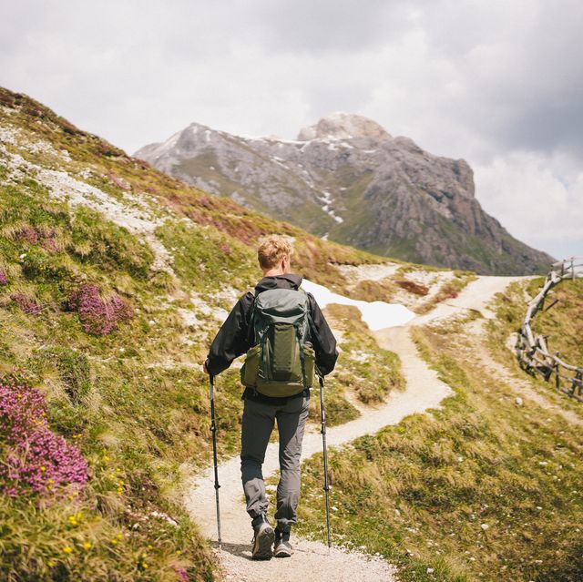 backpacker hikes trail in mountains