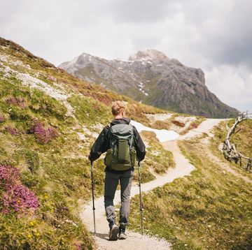backpacker hikes trail in mountains