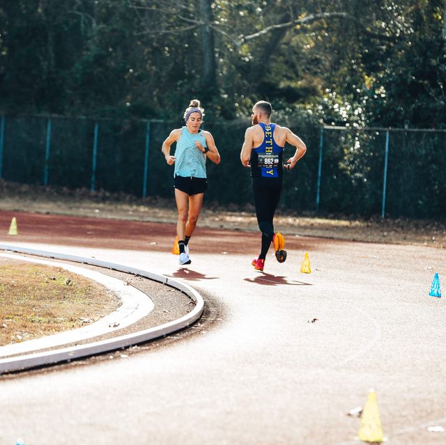 two people running on a track