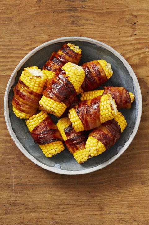 bacon wrapped corn on the cob in a bowl