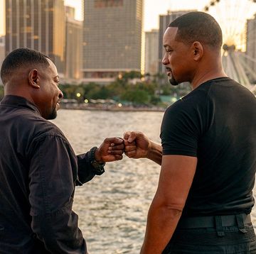 two men standing in miami doing a fist bump by the water