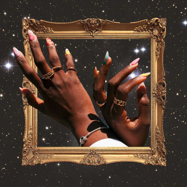 a black woman's hands showing off a manicure are placed inside a golden picture frame in a dark, starry sky