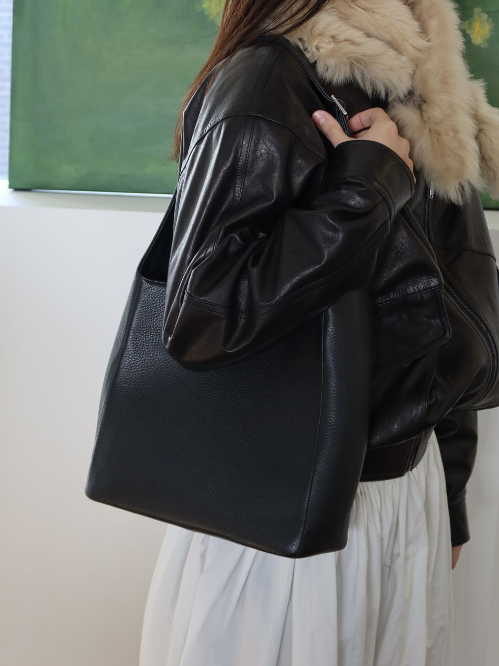 a person holding a black bag