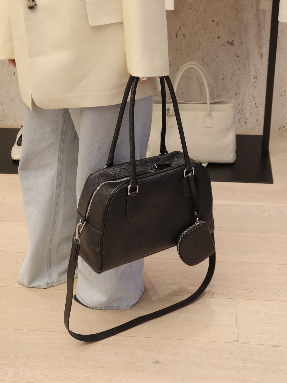a black handbag on a white surface
