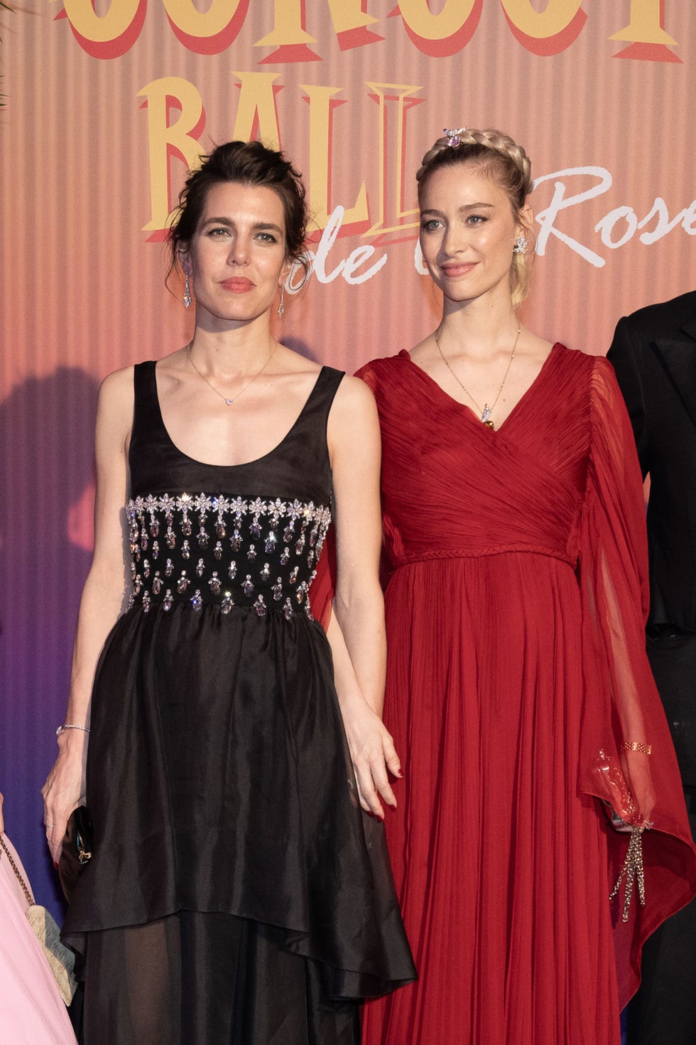 Two women in elegant evening dresses at a formal event