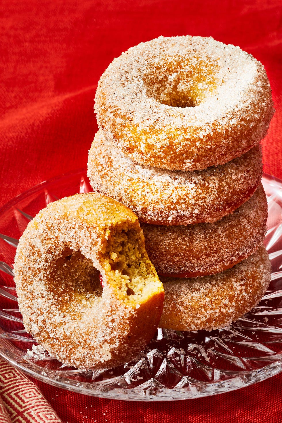 a stack of baked applesauce donuts on a glass plate