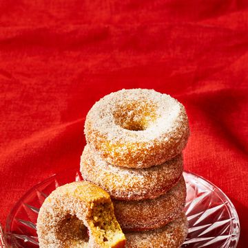 a stack of baked applesauce donuts on a glass plate
