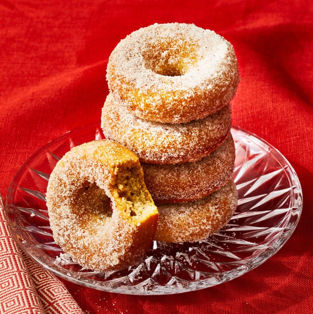 a stack of baked applesauce donuts on a glass plate