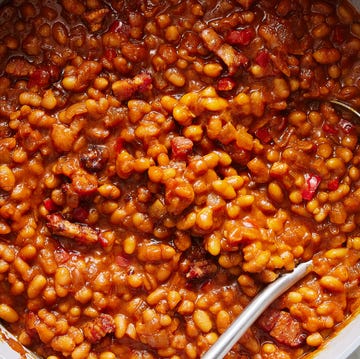 saucy baked beans scooped out of a pot