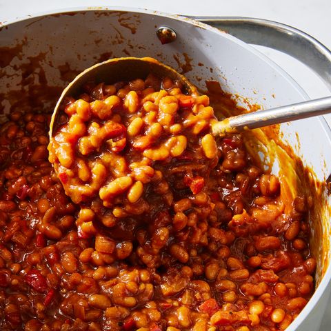 saucy baked beans scooped out of a pot
