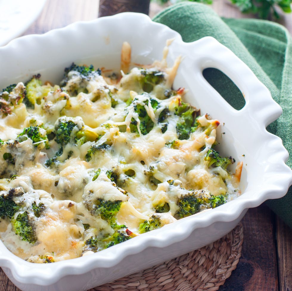 baked broccoli with chicken in a ceramic form on a wooden table, selective focus