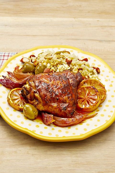 sheet pan chicken with lemons and olives and couscous on yellow polka dot plate