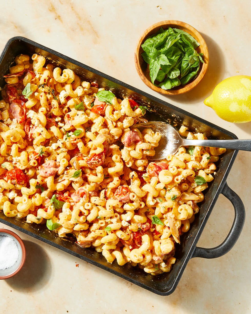 baked feta in a pan with roasted cherry tomatoes and shallots