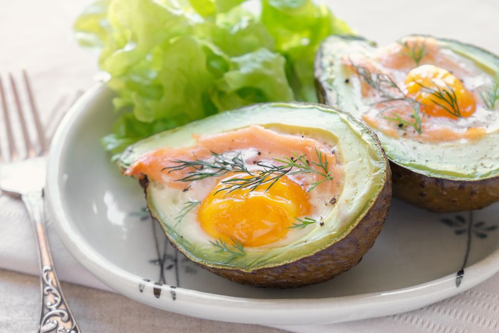 Baked smoked salmon, egg in avodaco, ketogenic keto low carb diet food
