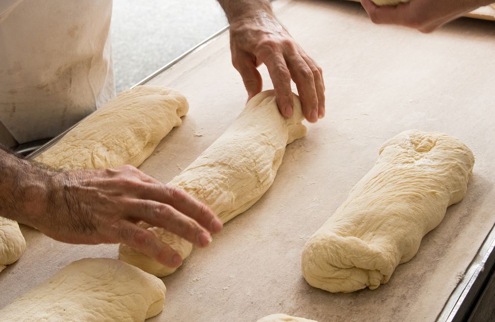 Bakers putting bread to a band for oven