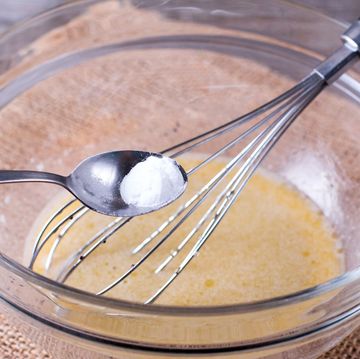 baking powder substitutes baking powder in spoon with bowl and whisk