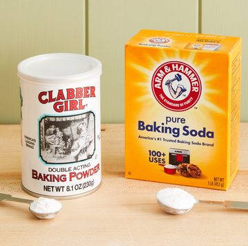 a can of baking powder and a box of baking soda on a table
