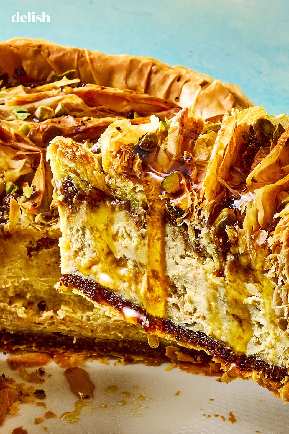 pistachio orange cheesecake with walnut and pistachio baklava crust and honey syrup