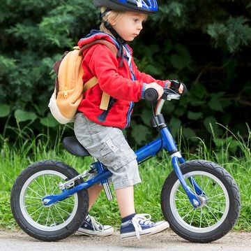 toddler riding blue balance bike