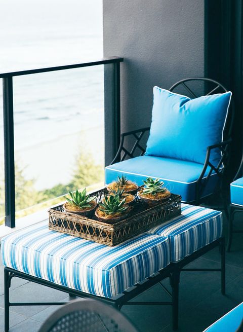 black balcony with blue and white patio furniture
