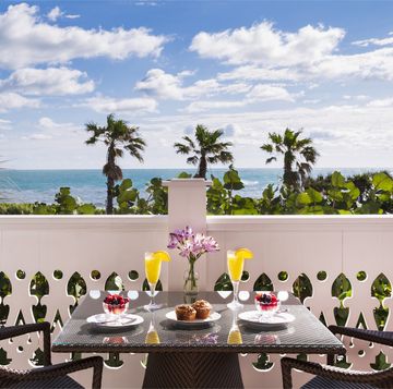 balcony overlooking ocean with breakfast and mimossas in tropical location