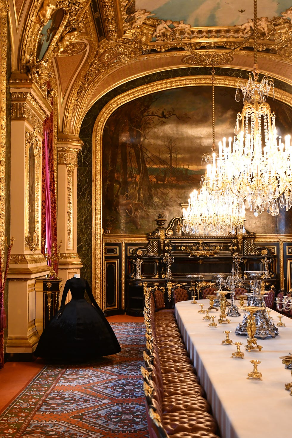 a black ballgown in lush art museum