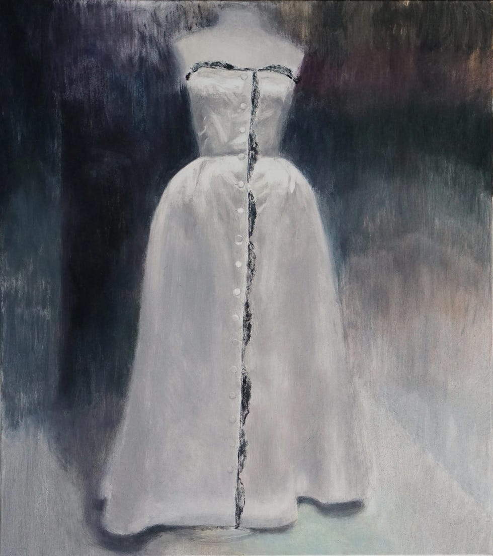 Łukasz Stokłosa a white dress displayed on a mannequin with a detailed button line