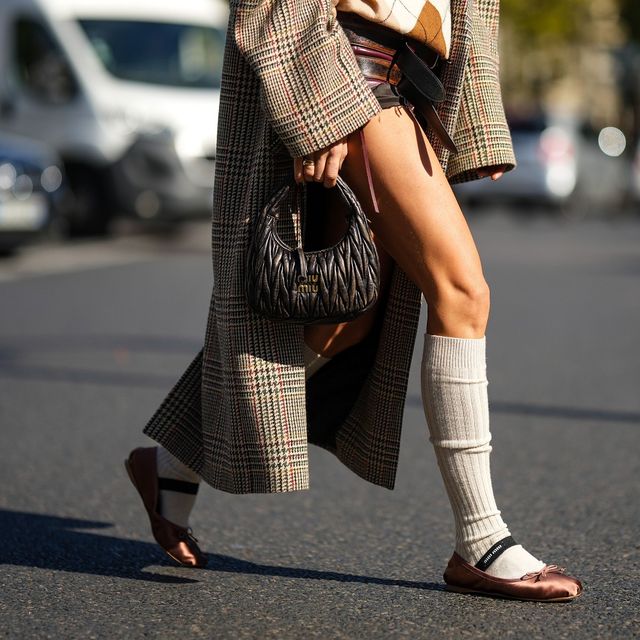 a woman wearing a skirt and heels