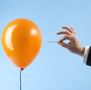 Balloon attacked by hand with needle