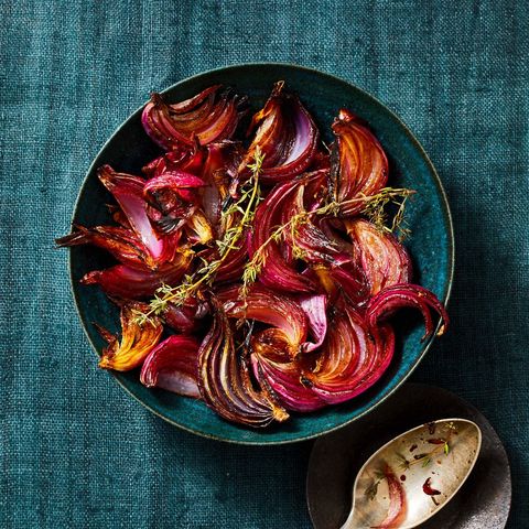 a close up of balsamic roasted red onions in a blue bowl