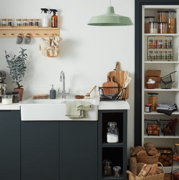 a kitchen with a white countertop and shelves with objects on it small kitchen ideas