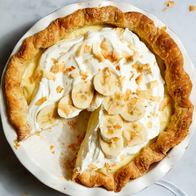 banana cream pie topped with banana slices and toasted coconut flakes