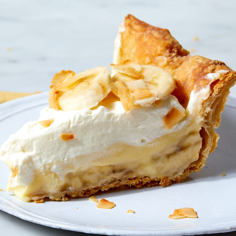 banana cream pie topped with banana slices and toasted coconut flakes