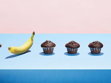 A banana in a row of chocolate cupcakes
