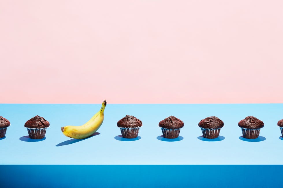 a banana in a row of chocolate cupcakes