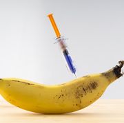 Banana potato with a laboratory syringe nailed to an experiment ; food concept transgenic and modified genetically.