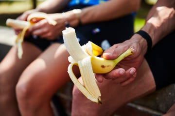 cyclists eating bananas after a ride