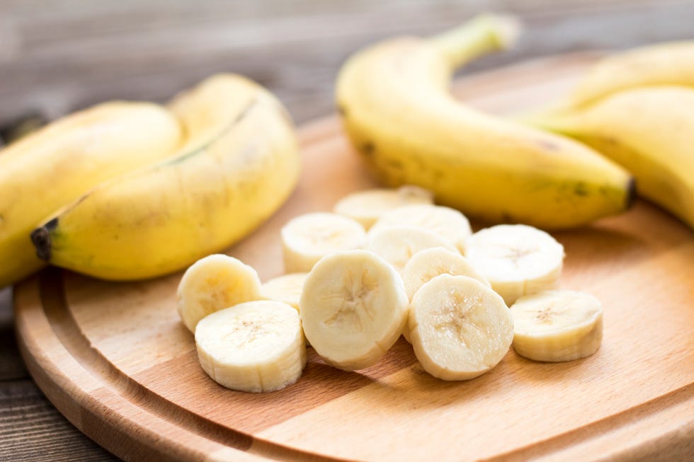 sliced bananas on wooden cutting board