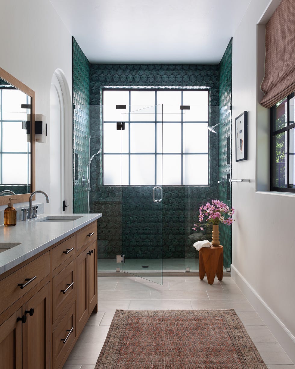 modern bathroom with a glass shower dual sink vanity and decorative tiles