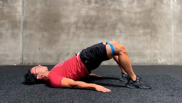 man preforming banded glute bridge exercise