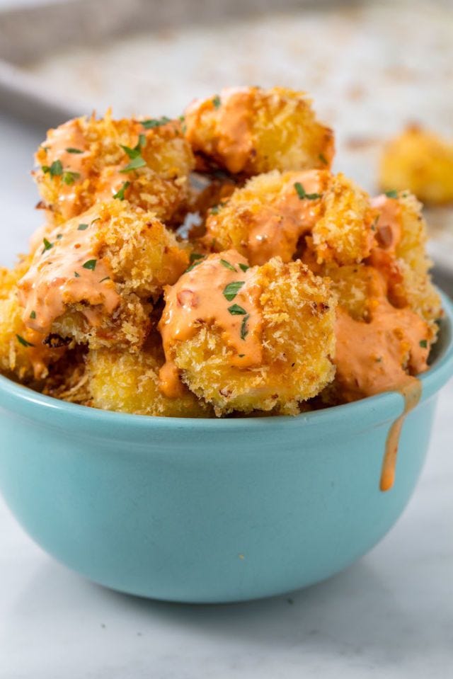 bang bang sauce covered fried shrimp in a teal bowl