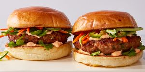 turkey burger topped with banh mi toppings like pickled carrots, jalapenos, and sriracha mayo