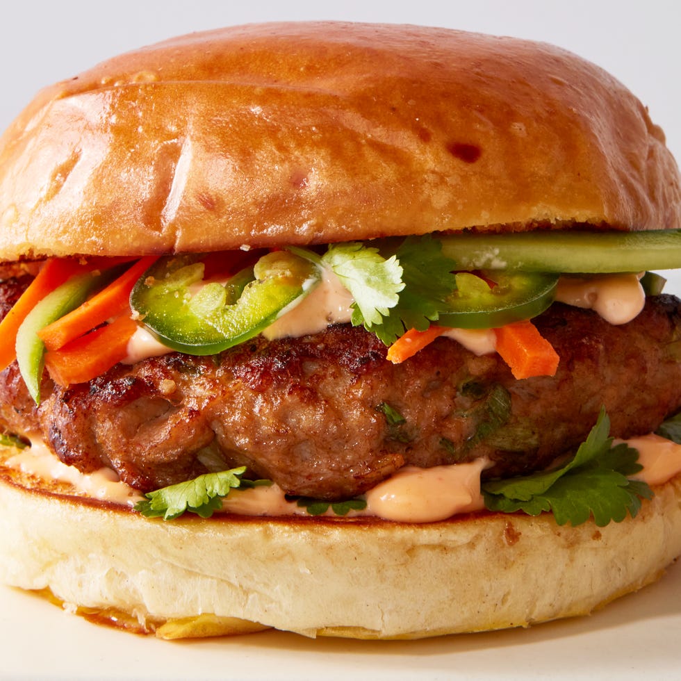 turkey burger topped with banh mi toppings like pickled carrots, jalapenos, and sriracha mayo