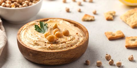 good carbs to eat, banner hummus of their chickpeas in a wooden plate vegetarian food