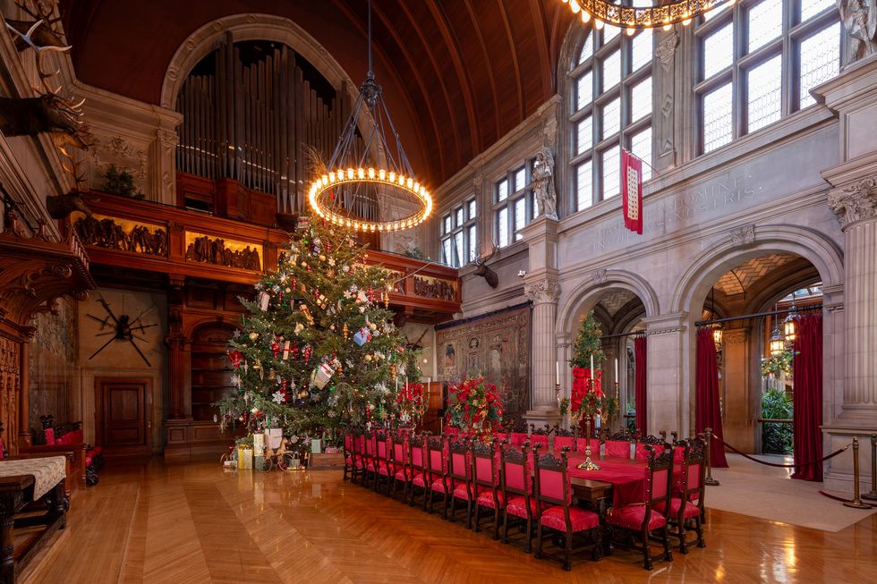 a large room with a christmas tree and chairs