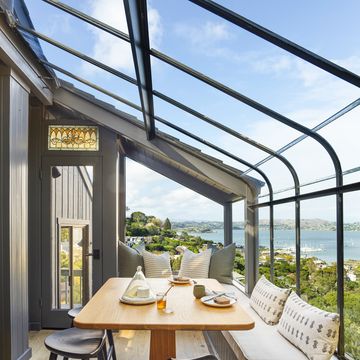 window nook overlooking the san francisco bay, this setup by designer heather k bernstein includes a table by santee design, pillows by susan connor ny, backless stools, and an extra long bench—allowing the view to take center stage