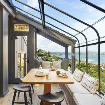 window nook overlooking the san francisco bay, this setup by designer heather k bernstein includes a table by santee design, pillows by susan connor ny, backless stools, and an extra long bench—allowing the view to take center stage