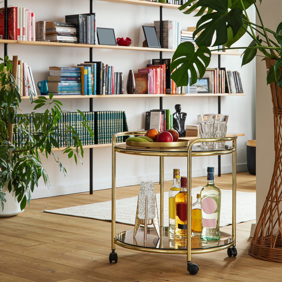 modern scandinavian home interior of living room with design retro furniture, tropical plant, window, decoration and elegant personal accessoreis in stylish home decor