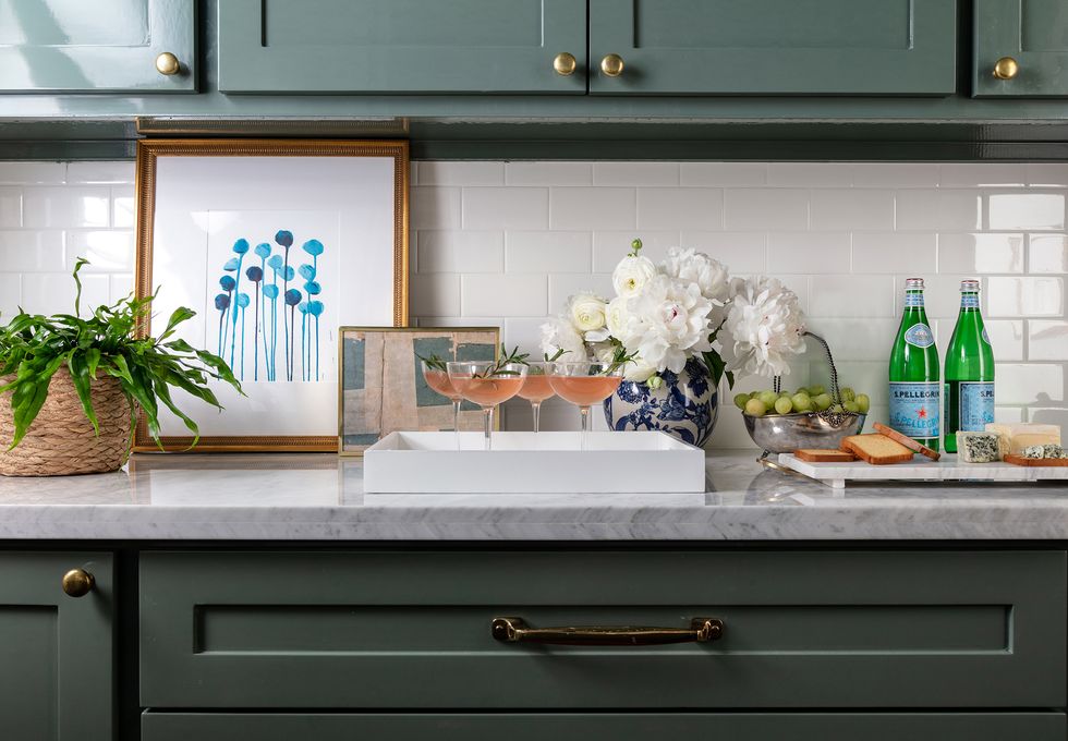 green cabinets and white tiled wall