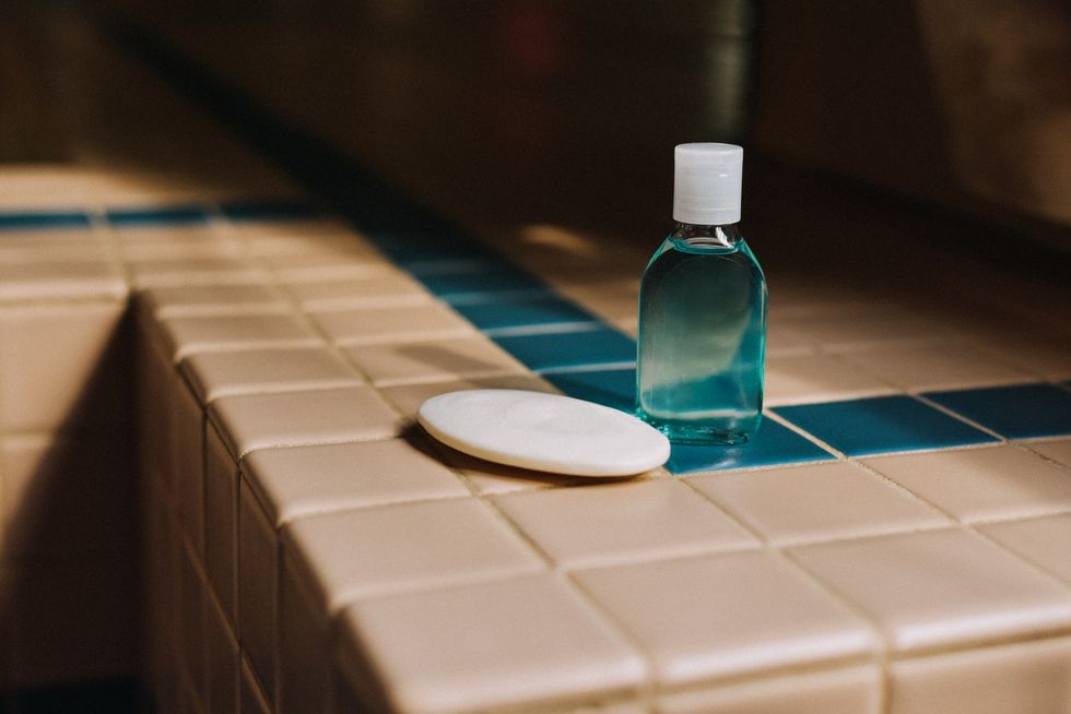 bar of soap and a travel size plastic bottle of liquid